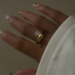 Asymmetrical Gold ring with emerald cut stone